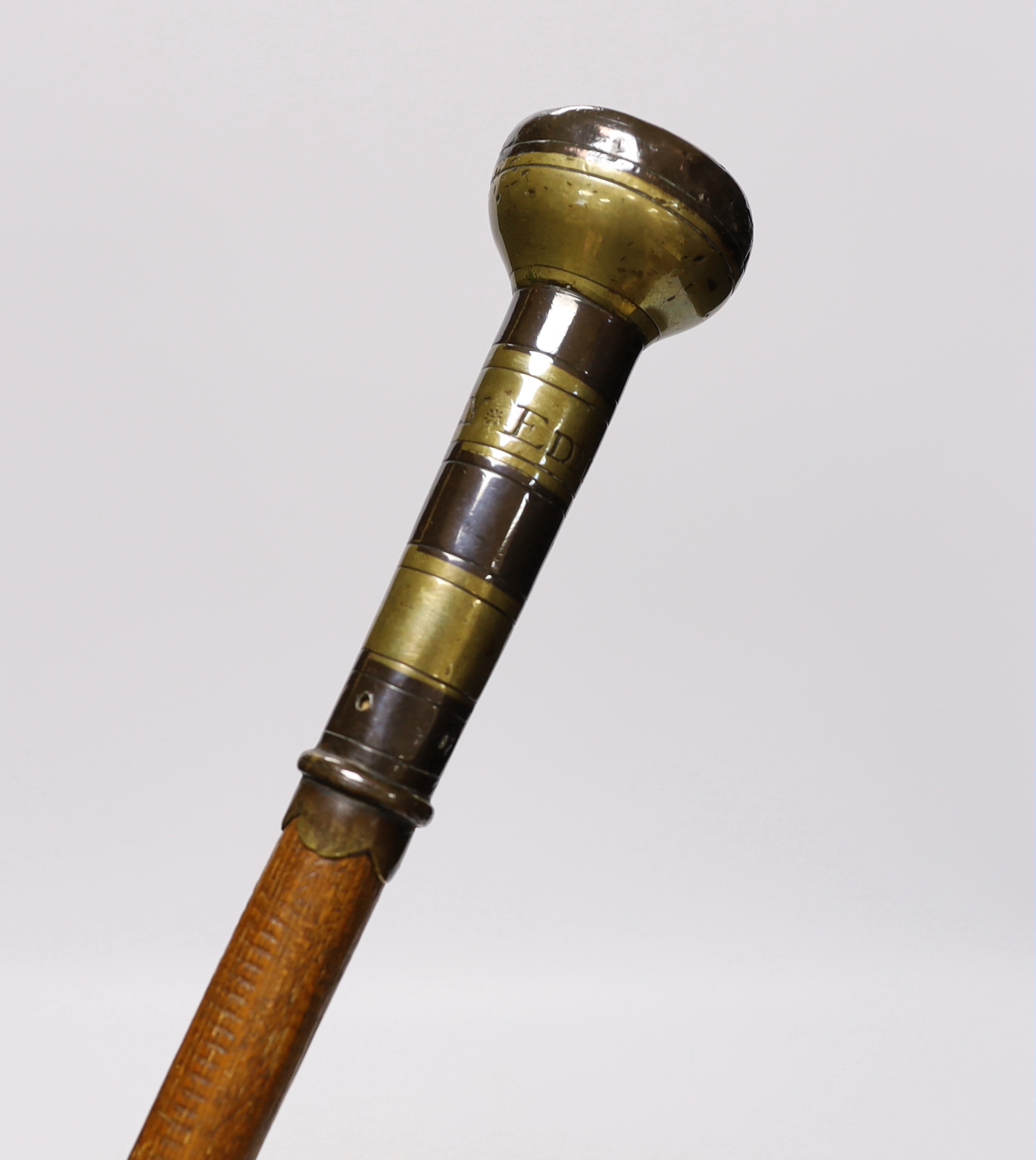 A walking cane, with engraved copper and brass handle, ‘Edmund Ivory, George King, 1741’, length 100cm
